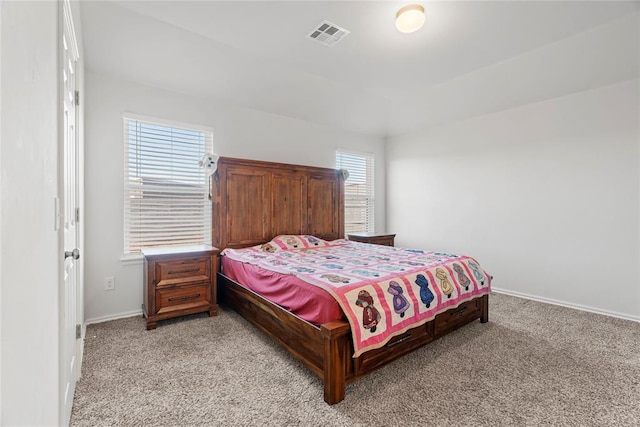 bedroom with light carpet, visible vents, and baseboards