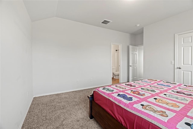 bedroom with visible vents, ensuite bathroom, carpet floors, baseboards, and vaulted ceiling