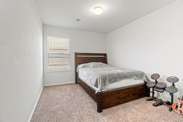 bedroom with baseboards, visible vents, and carpet floors