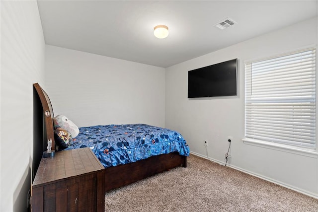 bedroom with visible vents, multiple windows, baseboards, and carpet floors