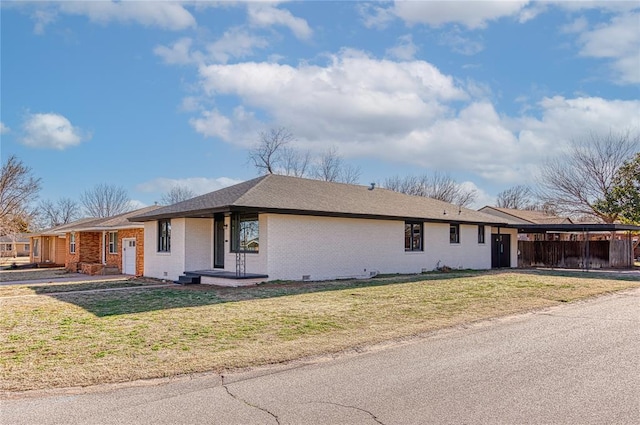 ranch-style house with brick siding and a front yard