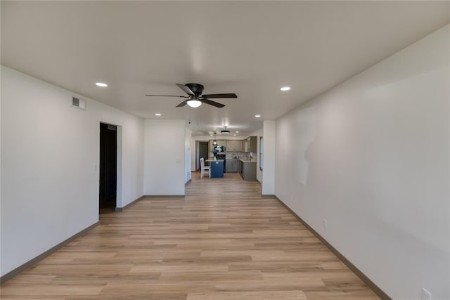 corridor with recessed lighting, light wood-style floors, visible vents, and baseboards