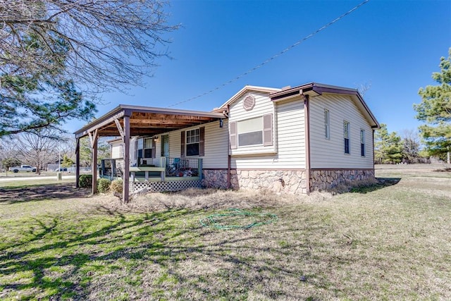 exterior space featuring a yard and covered porch