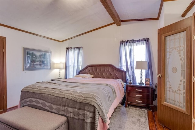 bedroom with multiple windows, vaulted ceiling with beams, ornamental molding, and wood finished floors