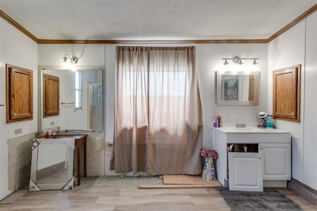 full bathroom featuring wood finished floors, vanity, and ornamental molding