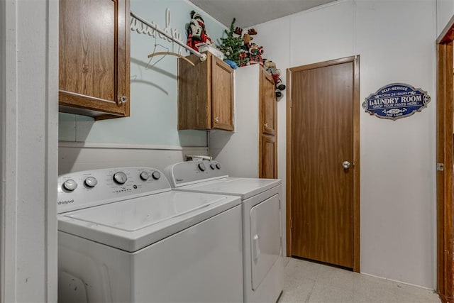 washroom featuring washer and dryer, cabinet space, and light floors