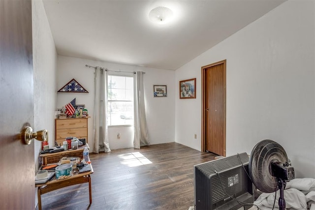 interior space featuring heating unit, wood finished floors, and vaulted ceiling