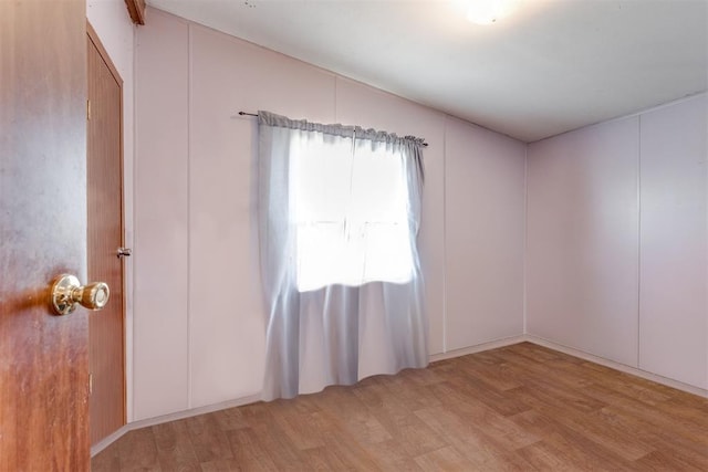 spare room featuring wood finished floors