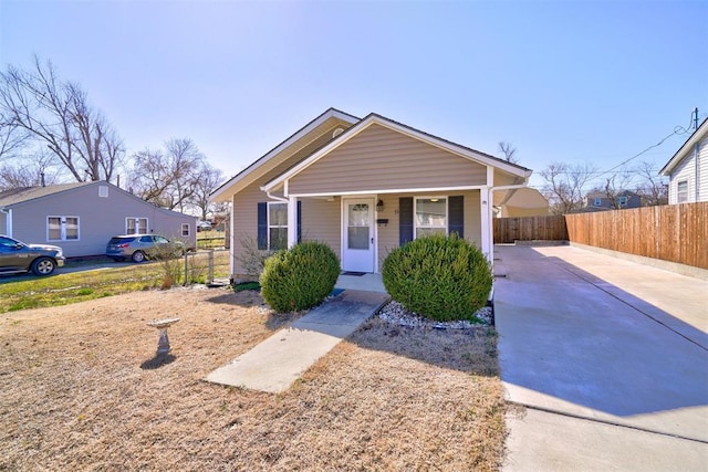 bungalow with a porch and fence