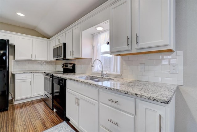 kitchen featuring dark wood finished floors, white cabinetry, black appliances, and a sink