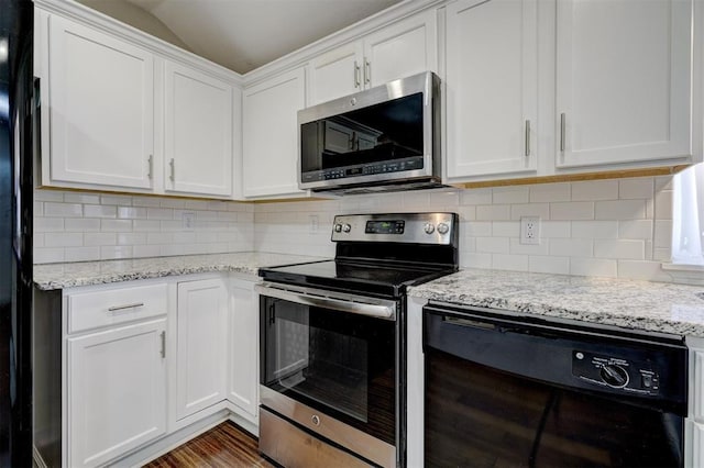 kitchen with black appliances, white cabinets, light stone counters, and backsplash