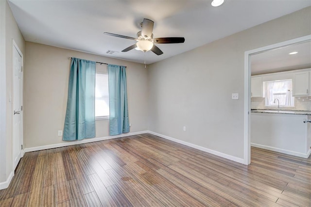 unfurnished room with visible vents, baseboards, and light wood-style floors