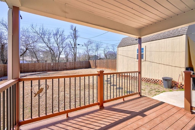 deck with an outbuilding and a fenced backyard