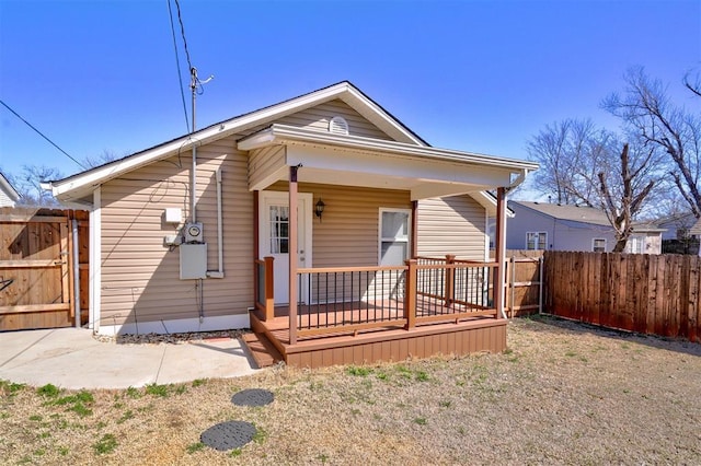 view of front of property with a porch and fence