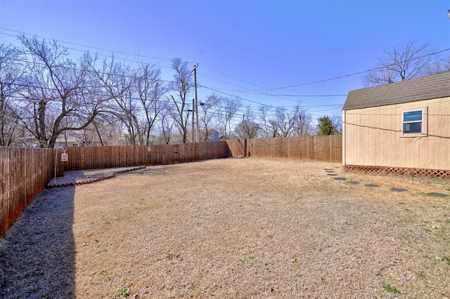 view of yard with a fenced backyard and an outdoor structure