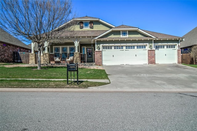 craftsman-style house with brick siding, a front lawn, fence, concrete driveway, and a garage