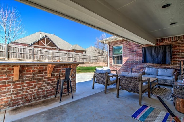 view of patio / terrace with outdoor dry bar, outdoor lounge area, and a fenced backyard