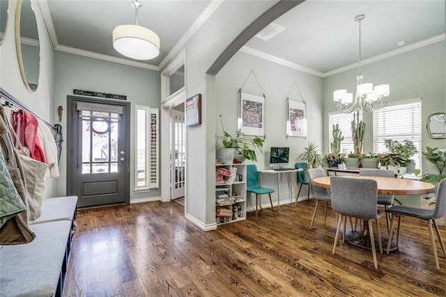 entryway with wood finished floors, baseboards, arched walkways, ornamental molding, and a chandelier