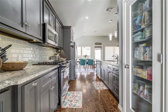 kitchen with a sink, stainless steel appliances, visible vents, and gray cabinetry