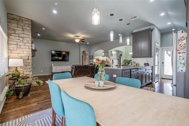 dining room featuring visible vents, dark wood-type flooring, ceiling fan, recessed lighting, and arched walkways