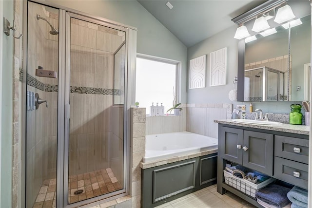 bathroom with vanity, tile patterned flooring, vaulted ceiling, a shower stall, and a bath