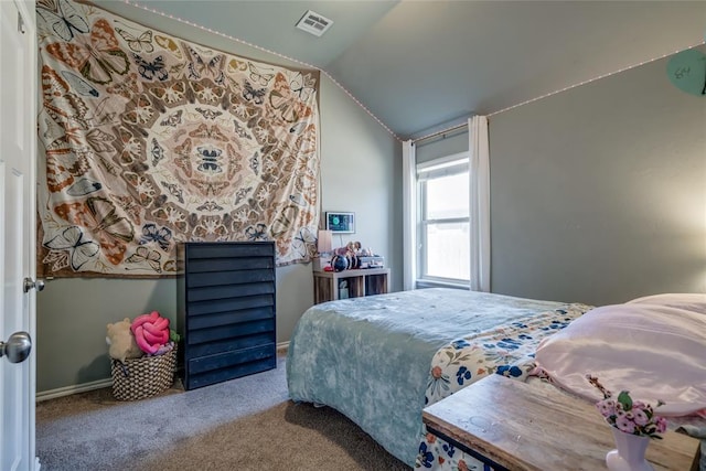 carpeted bedroom with visible vents and vaulted ceiling