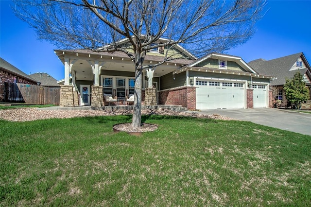 craftsman-style home with a front lawn, fence, concrete driveway, an attached garage, and brick siding