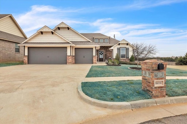 craftsman house with concrete driveway, brick siding, a garage, and a shingled roof