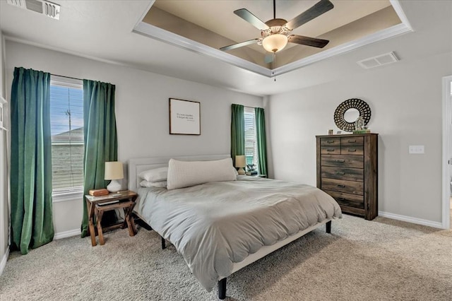 bedroom featuring visible vents, a raised ceiling, baseboards, and carpet floors