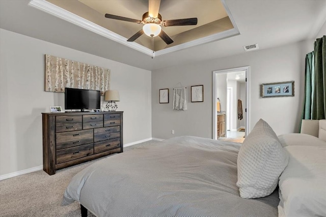 carpeted bedroom with visible vents, a ceiling fan, a raised ceiling, and baseboards