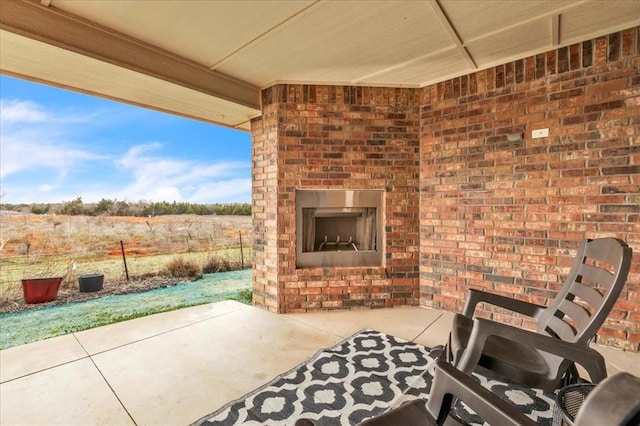 view of patio with an outdoor brick fireplace