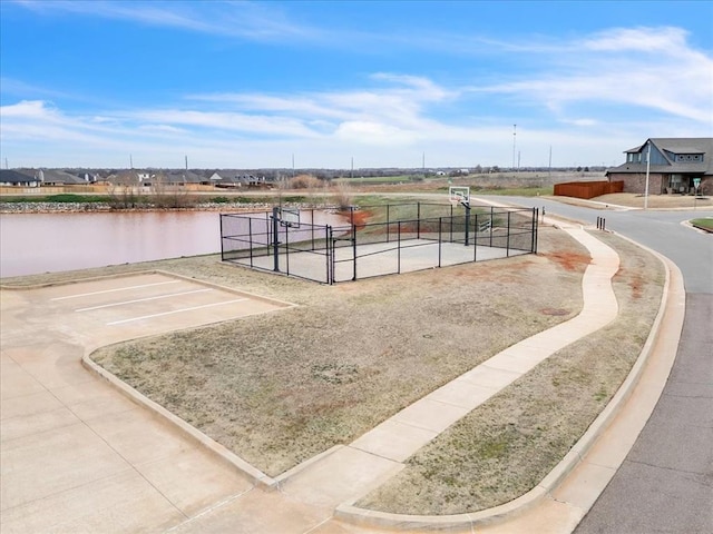 view of home's community featuring a gate, fence, and a water view