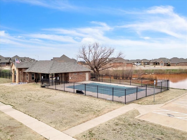 view of swimming pool featuring a fenced in pool, a patio area, fence, and a residential view