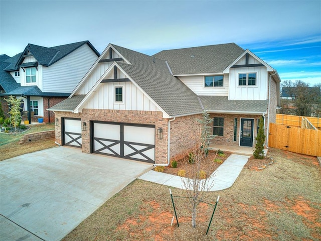 view of front of house featuring brick siding, fence, board and batten siding, and roof with shingles