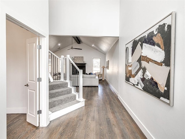 entryway featuring stairway, a ceiling fan, dark wood-type flooring, and baseboards