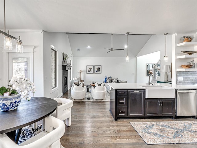 kitchen featuring a ceiling fan, lofted ceiling, open shelves, a sink, and dishwasher