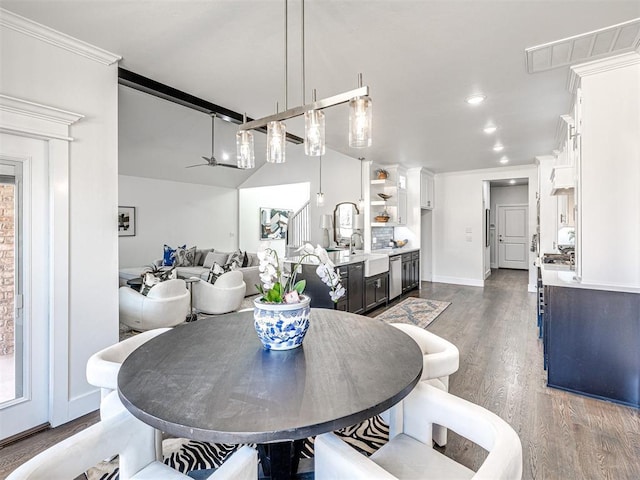 dining room featuring a ceiling fan, wood finished floors, visible vents, baseboards, and ornamental molding