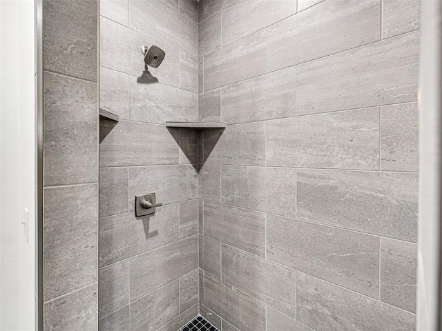 bathroom with tiled shower