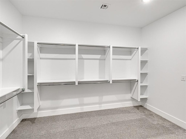 walk in closet featuring carpet flooring and visible vents