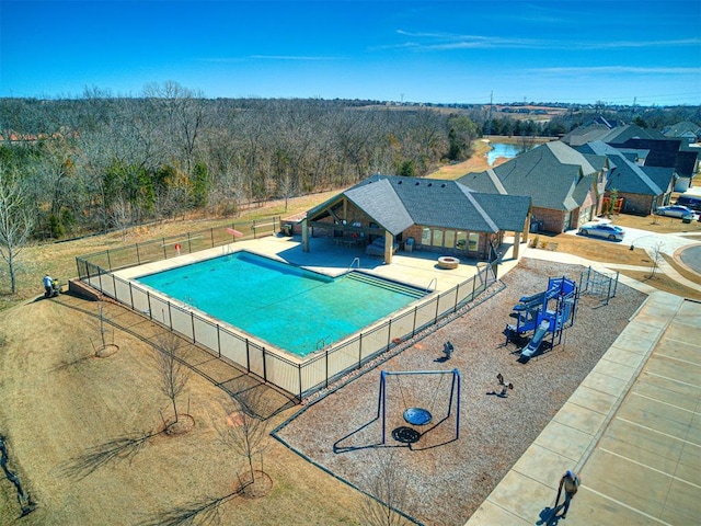 view of swimming pool with a patio area and fence