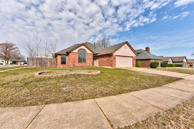 single story home featuring a front yard, fence, an attached garage, concrete driveway, and brick siding