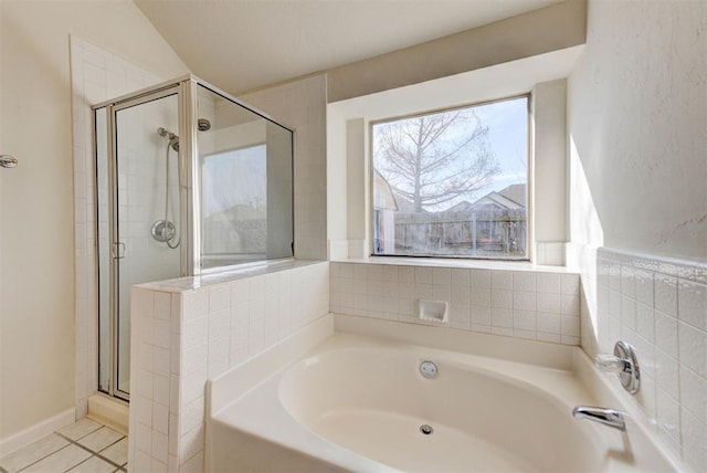 full bathroom featuring tile patterned floors, a garden tub, and a shower stall