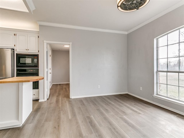 kitchen with visible vents, crown molding, white cabinets, black appliances, and wood counters