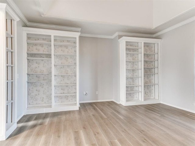 unfurnished room featuring light wood-type flooring, baseboards, and ornamental molding