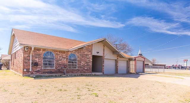 view of front of house with concrete driveway, an attached garage, and brick siding