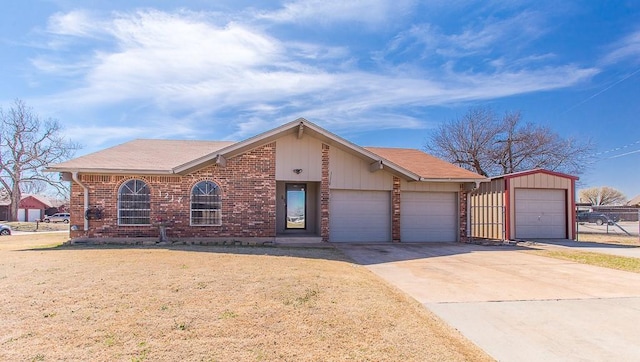 view of front of property featuring concrete driveway, a garage, and brick siding