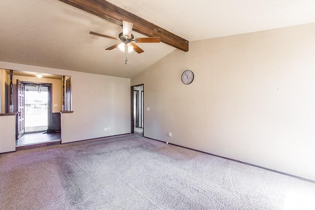 carpeted empty room featuring baseboards, a textured ceiling, lofted ceiling with beams, and ceiling fan