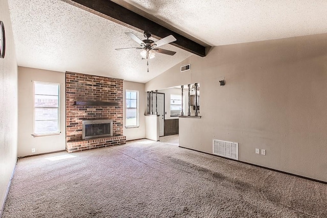 unfurnished living room with carpet flooring, a fireplace, and visible vents