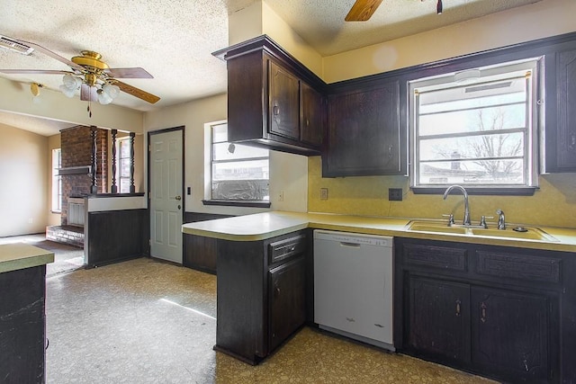 kitchen with visible vents, dishwasher, light countertops, a peninsula, and a sink