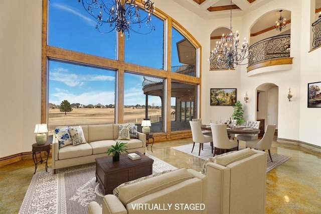 living area featuring baseboards, coffered ceiling, an inviting chandelier, a high ceiling, and arched walkways